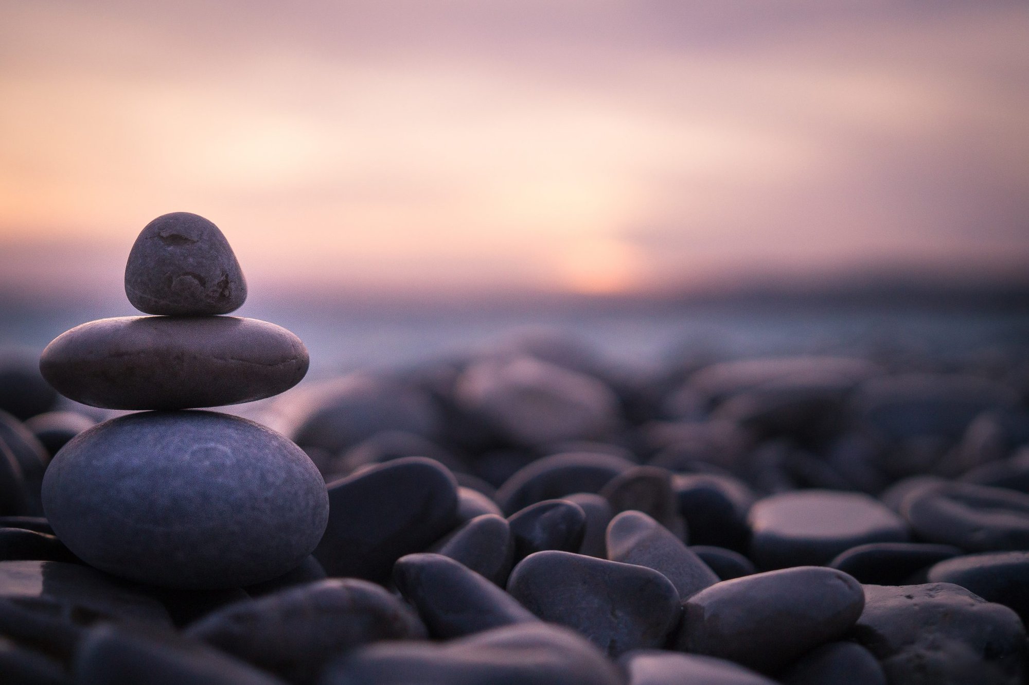 Relaxing photo of pebbles stacked by the water